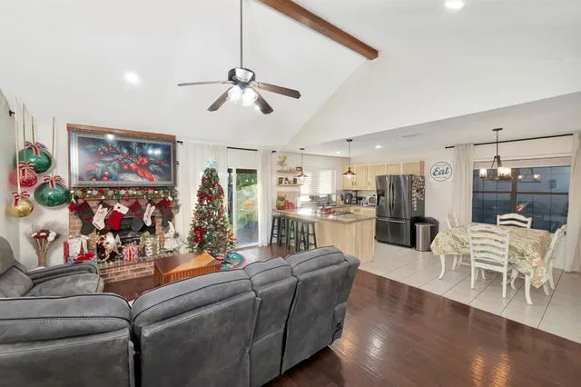 a living room with furniture and kitchen view