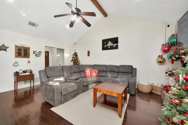 a living room with furniture and flowers