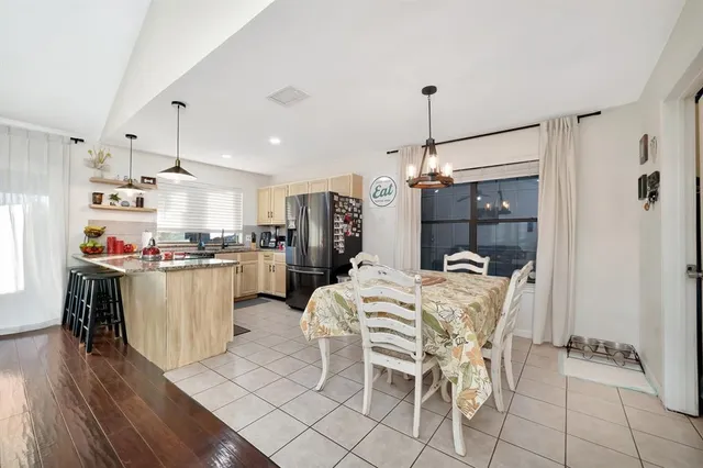 a kitchen with kitchen island white cabinets and refrigerator