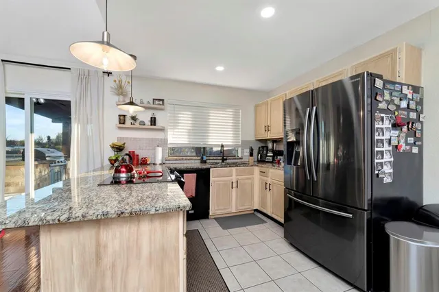 a kitchen with refrigerator and cabinets
