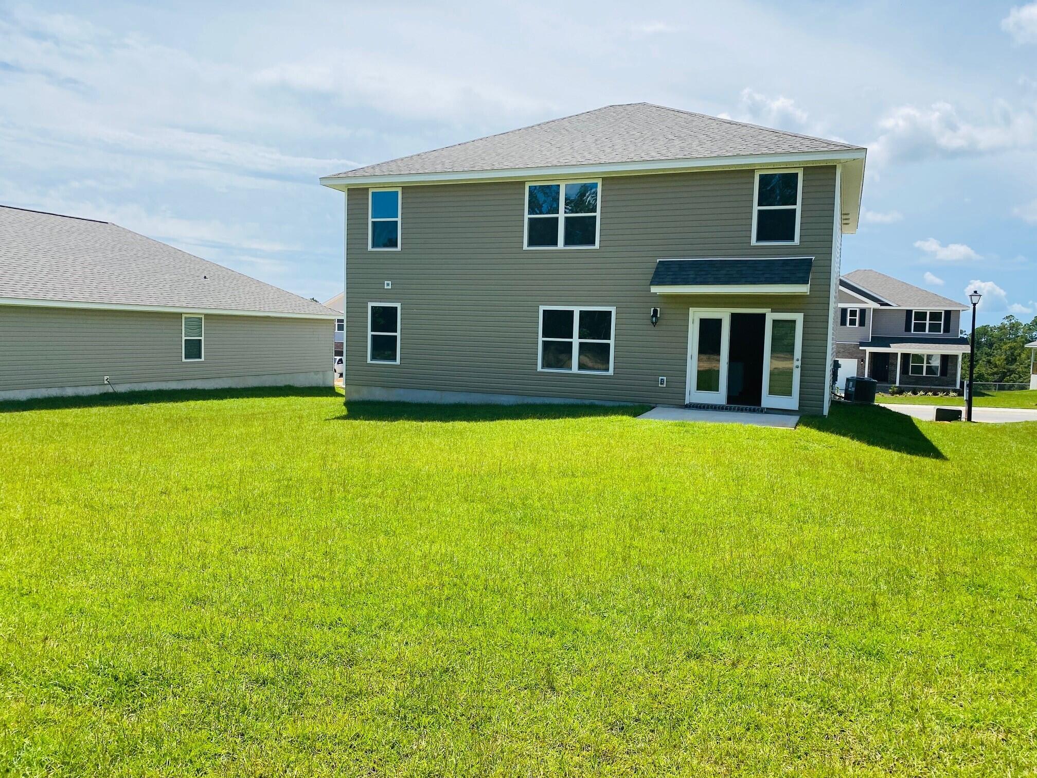 3262 Chapelwood Drive Crestview, FL 32539 - Photo 14 of 15 a house that has a big yard with wooden fence
