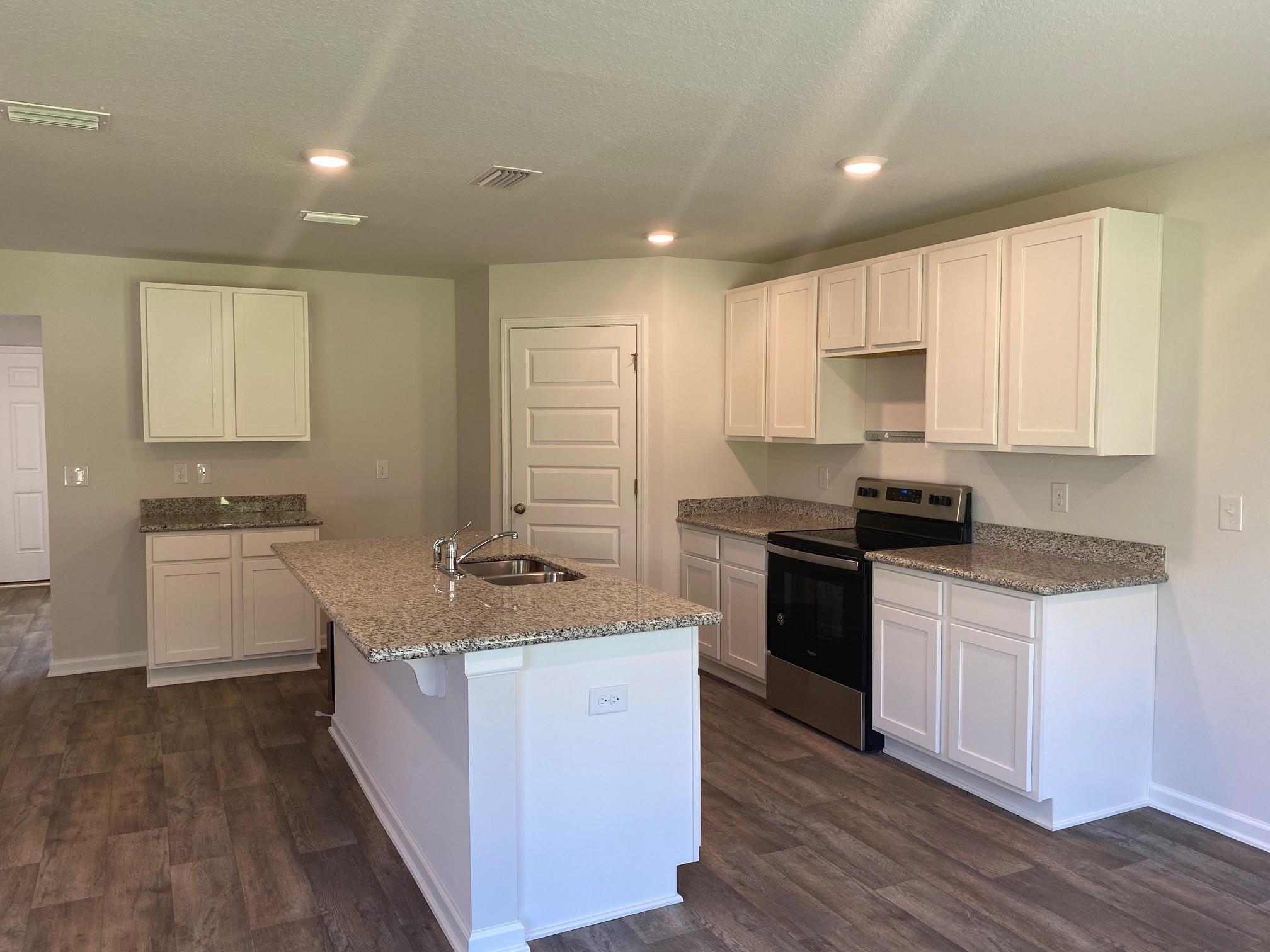 3262 Chapelwood Drive Crestview, FL 32539 - Photo 4 of 15 a kitchen with stainless steel appliances granite countertop a stove a sink and a refrigerator