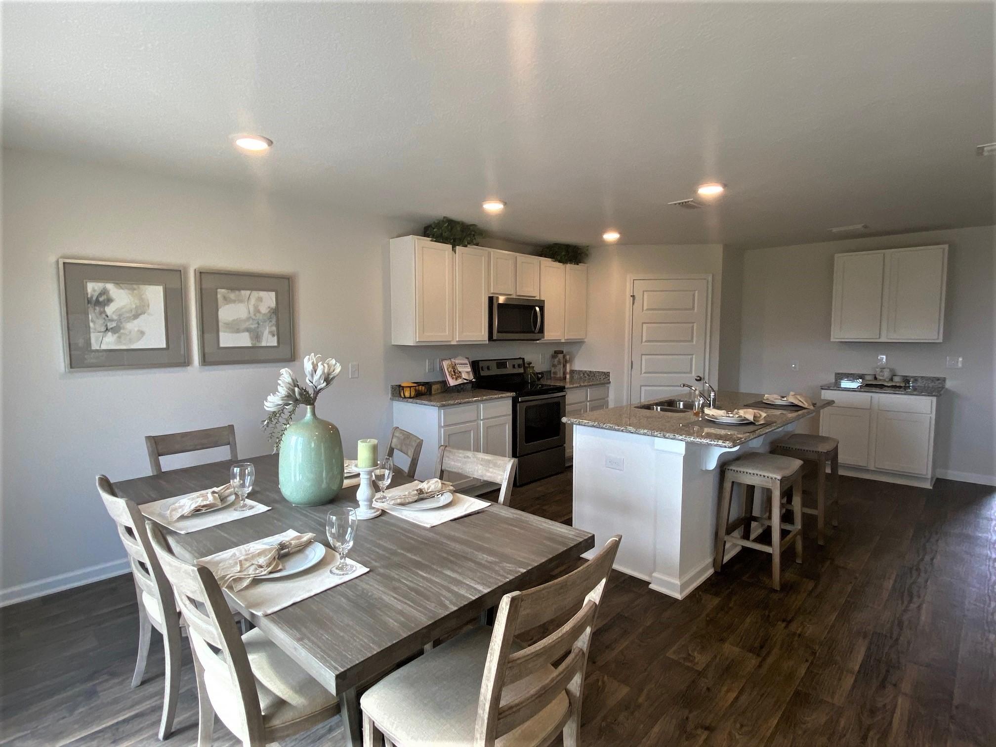 3262 Chapelwood Drive Crestview, FL 32539 - Photo 5 of 15 a kitchen with a dining table chairs and microwave