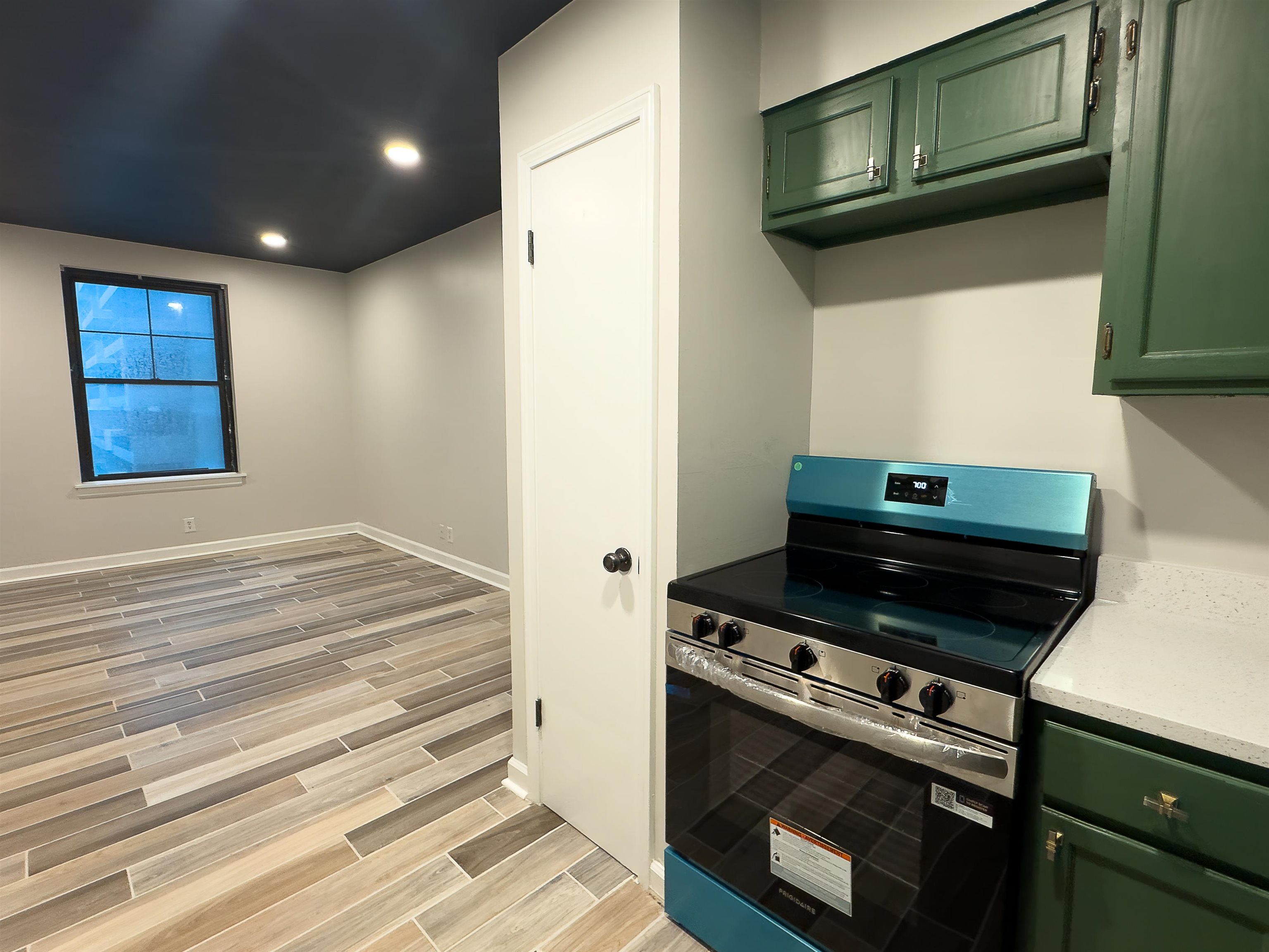 109 North Main Street, Unit 907 Memphis, TN 38103 - Photo 8 of 29 New stainless steel range, white countertops, and vibrant green cabinetry