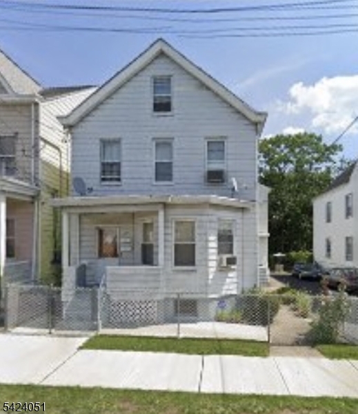 a view of a house with a yard and plants