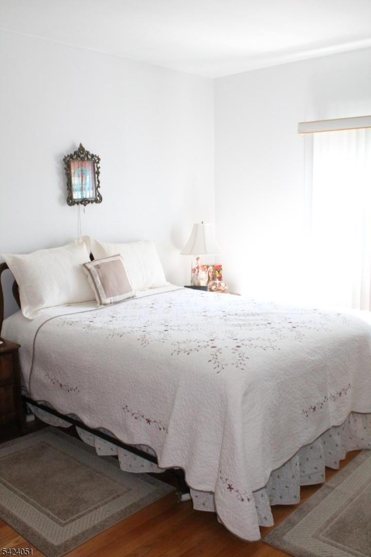 79 Nagle Street Paterson, NJ 07501 - Photo 2 of 7 a bedroom with a bed and a night stand