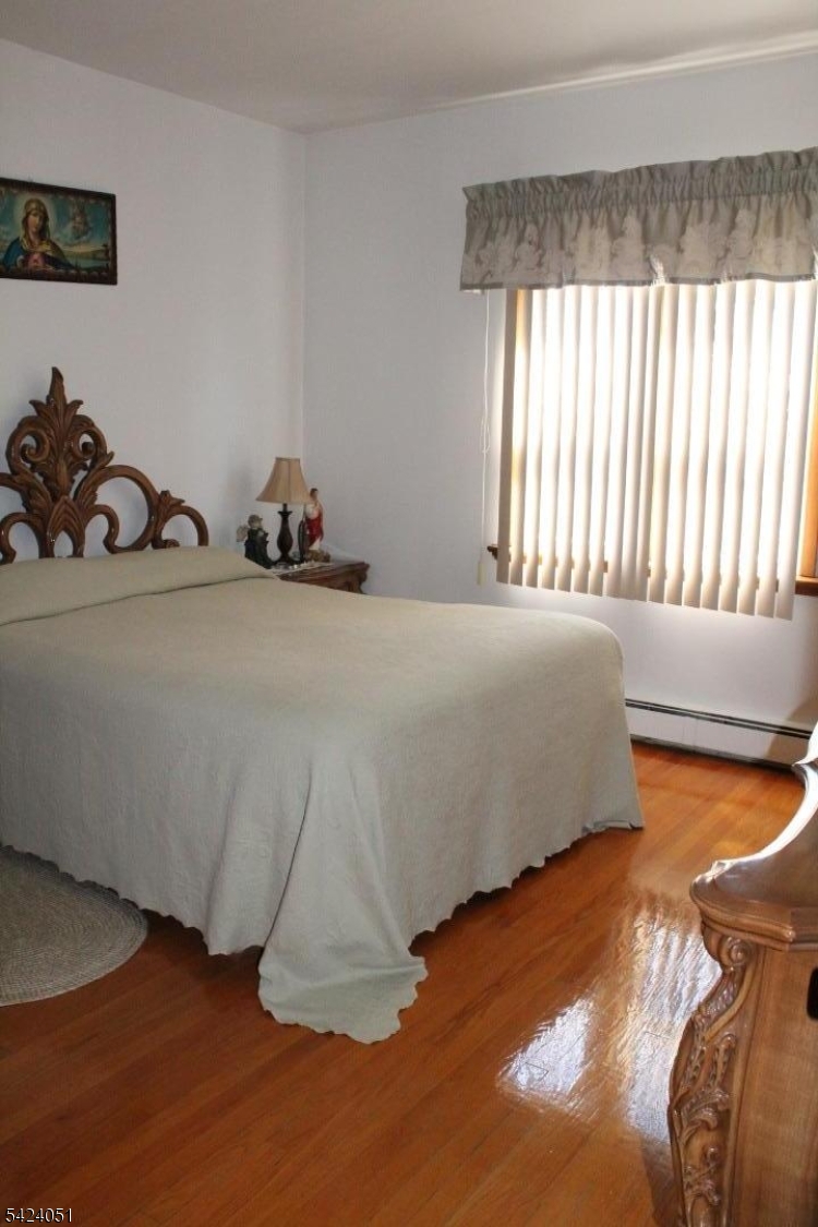 79 Nagle Street Paterson, NJ 07501 - Photo 4 of 7 a bedroom with a bed and a dresser