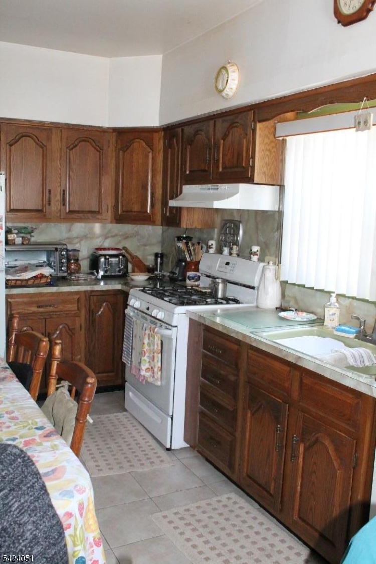 79 Nagle Street Paterson, NJ 07501 - Photo 6 of 7 a kitchen with a sink appliances and cabinets