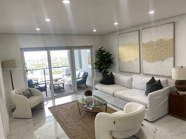 a living room with a flat screen tv and white walls