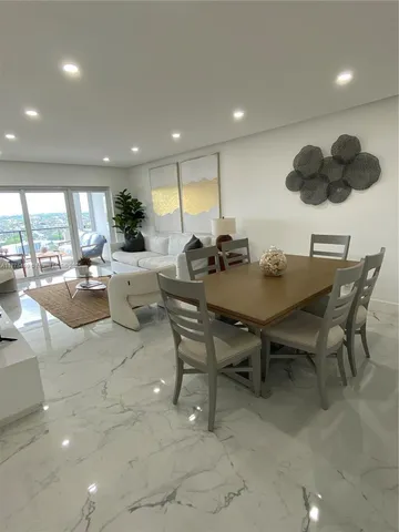 a living room with couches and a flat screen tv