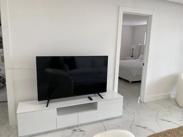 a view of yard from deck with patio