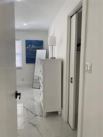 a view of a dining room with furniture floor to ceiling window and potted plants