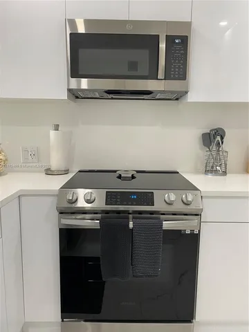 a close view of a sink a faucet and appliances in the kitchen