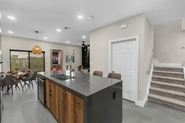 a kitchen with sink refrigerator and cabinets