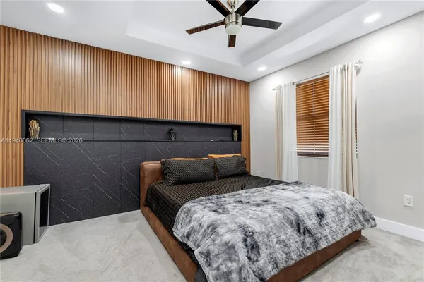 a bedroom with a bed and a ceiling fan