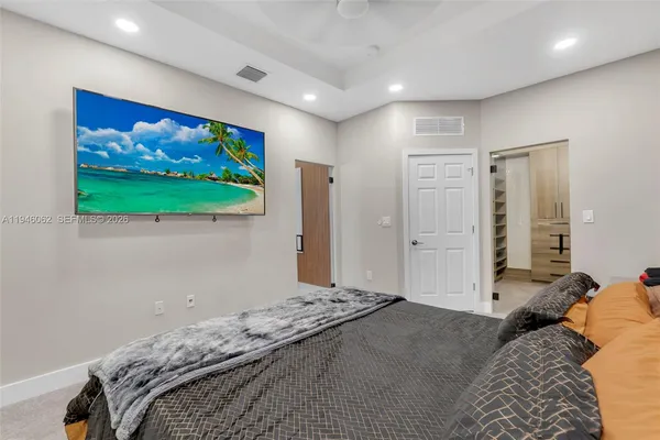 a bedroom with a bed and painting on the wall
