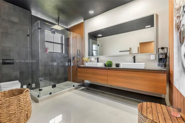 a bathroom with a white bath tub sitting next to a bathroom sink and a shower