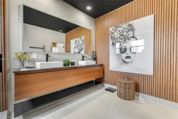a bathroom with a large mirror and a sink