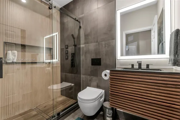 a bathroom with a sink toilet and shower