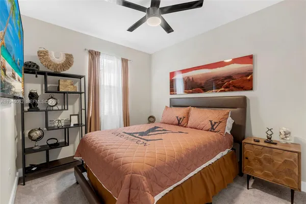 a bedroom with a bed and a painting on the wall