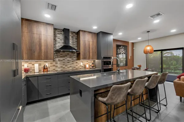 a kitchen with stainless steel appliances granite countertop sink stove and cabinets