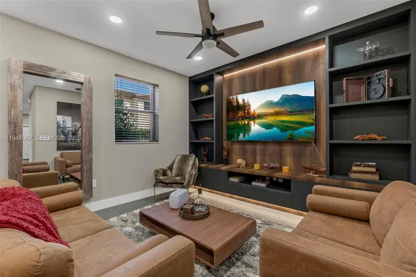 a living room with furniture and a flat screen tv