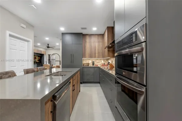 a large kitchen with granite countertop a large stove top oven