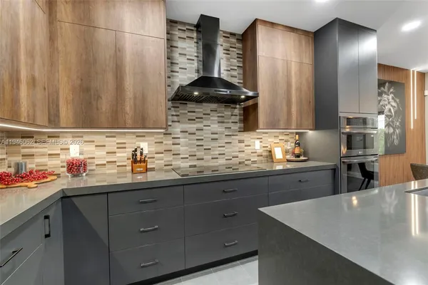 a kitchen with stainless steel appliances a sink dishwasher and cabinets