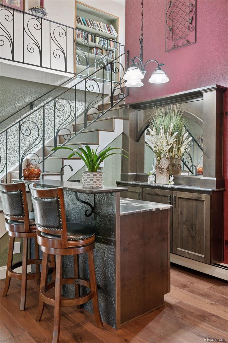 16990 Old Pueblo Road Fountain, CO 80817 - Photo 11 of 50 a kitchen with stainless steel appliances kitchen island granite countertop a table and chairs in it