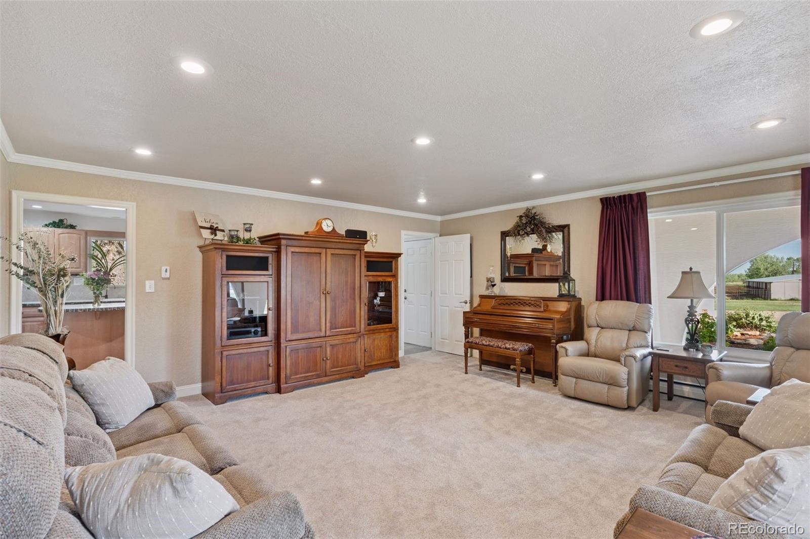 16990 Old Pueblo Road Fountain, CO 80817 - Photo 13 of 50 a living room with furniture and a flat screen tv