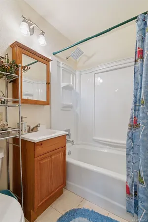 a bathroom with a granite countertop sink mirror vanity and bathtub