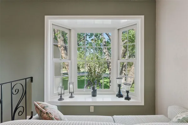 a living room with large window and a wooden floor