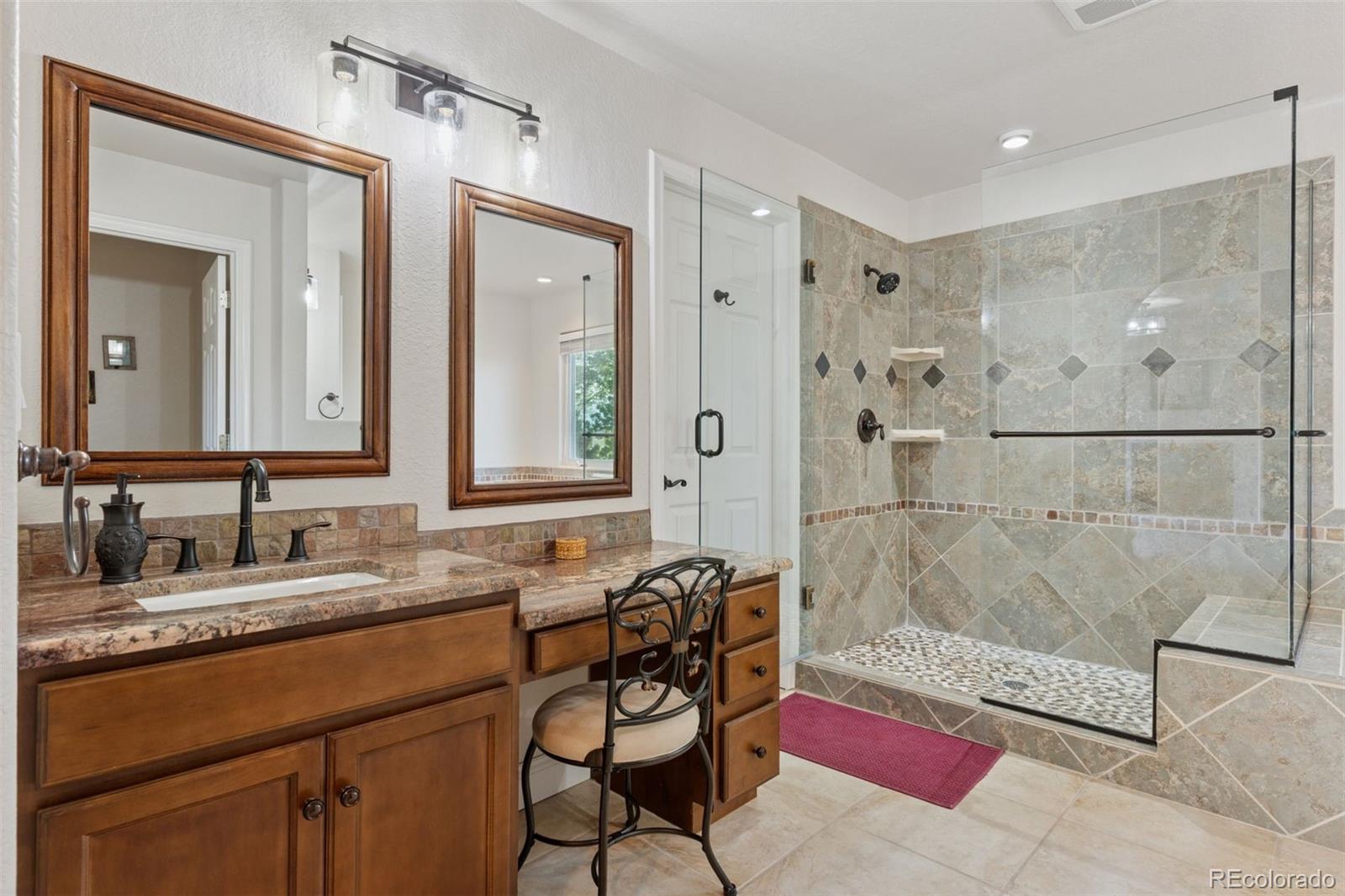 16990 Old Pueblo Road Fountain, CO 80817 - Photo 24 of 50 a bathroom with a granite countertop sink mirror and a shower