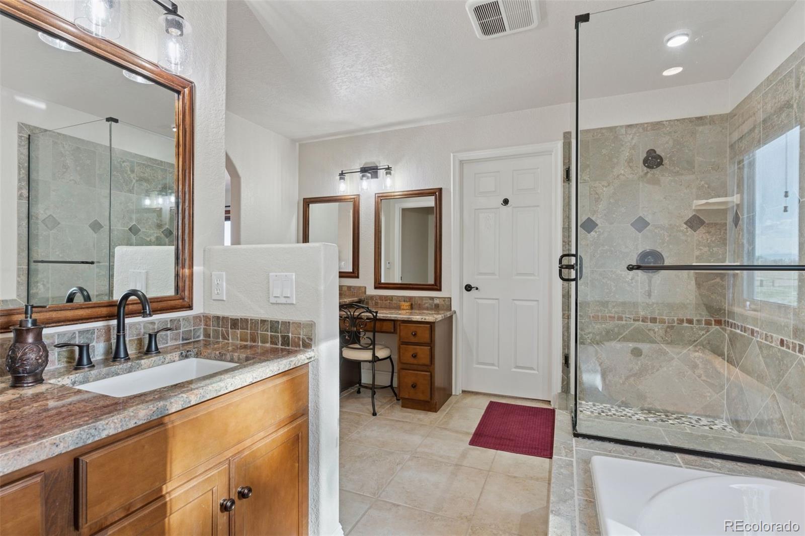 16990 Old Pueblo Road Fountain, CO 80817 - Photo 25 of 50 a bathroom with a granite countertop tub sink shower and mirror