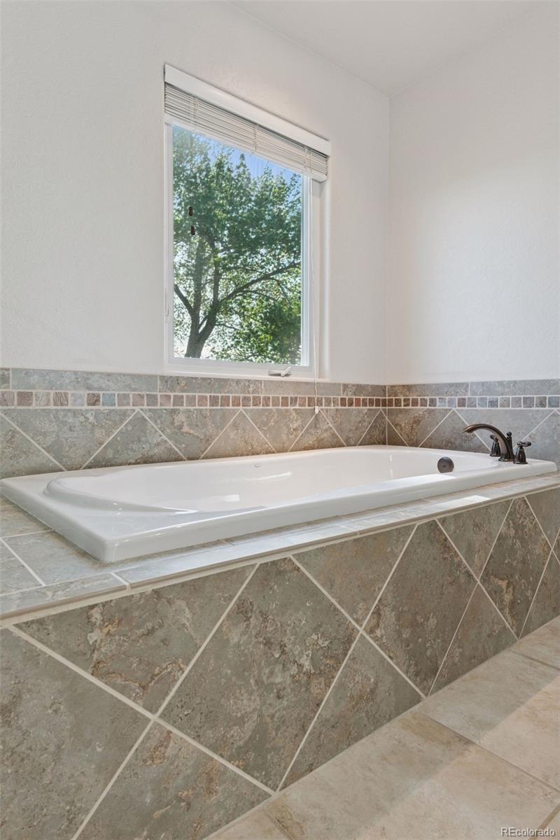 16990 Old Pueblo Road Fountain, CO 80817 - Photo 26 of 50 a bathroom with a bathtub and a window