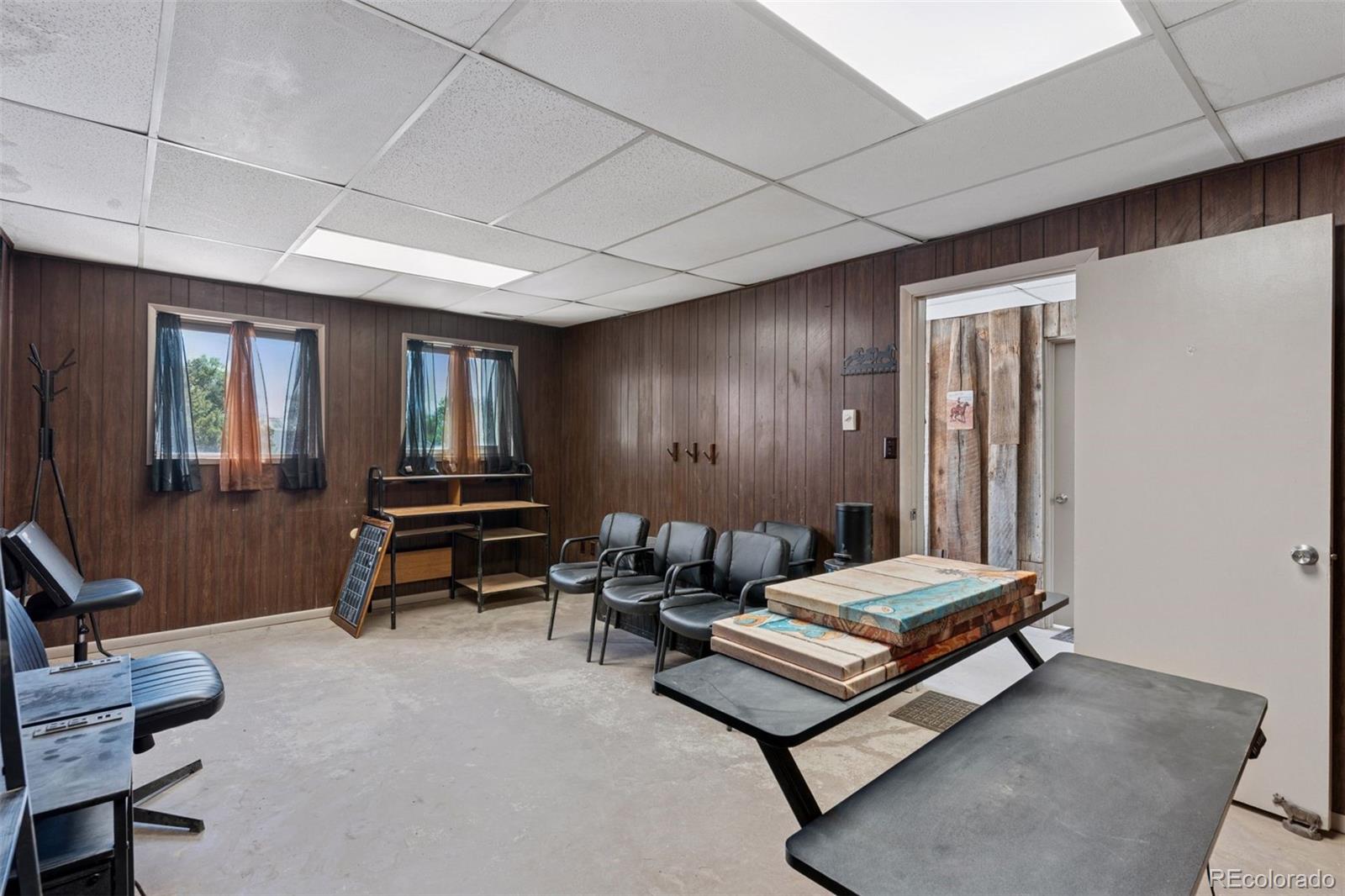 16990 Old Pueblo Road Fountain, CO 80817 - Photo 37 of 50 a living room with furniture a desk and chair with the wooden floor