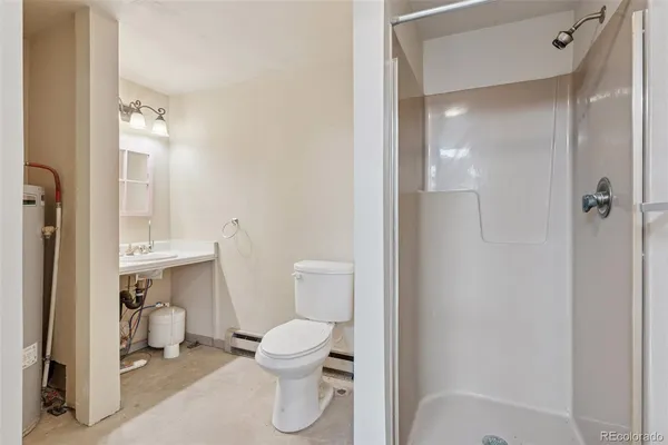 a bathroom with a toilet and a shower