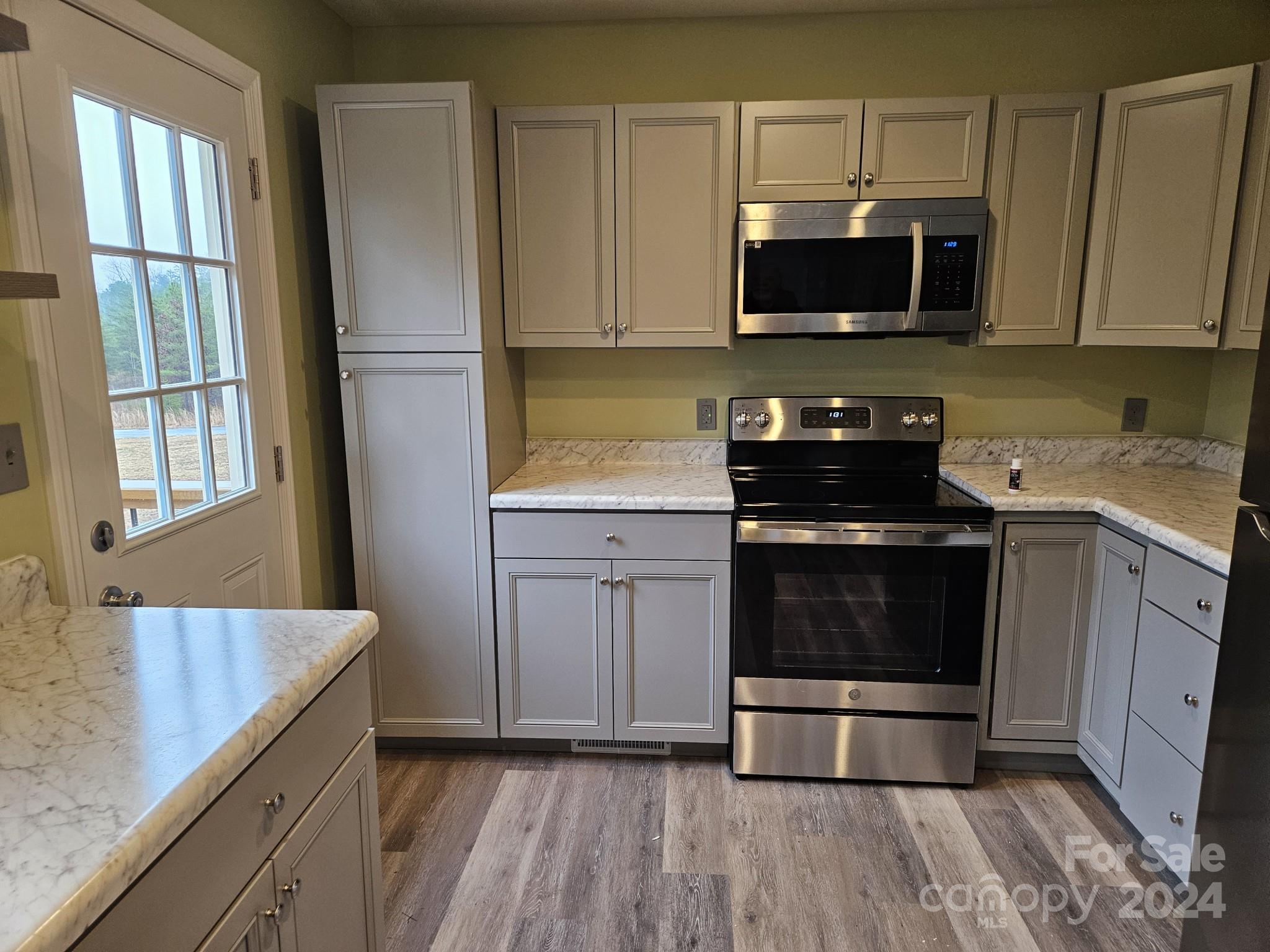 125 Diamond Loop Rutherfordton, NC 28139 - Photo 9 of 28 a kitchen with stainless steel appliances granite countertop a stove a microwave and a sink