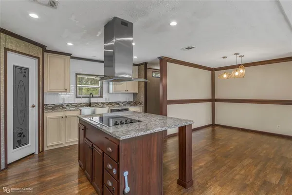 a kitchen with a stove a refrigerator and a sink
