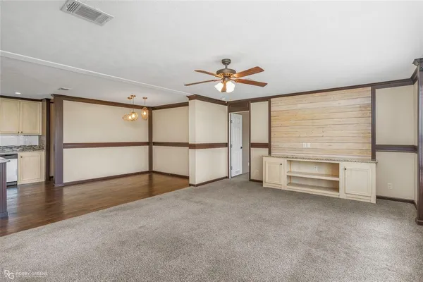 a view of a kitchen with furniture and a ceiling fan