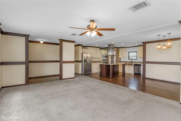 a view of empty room with ceiling fan