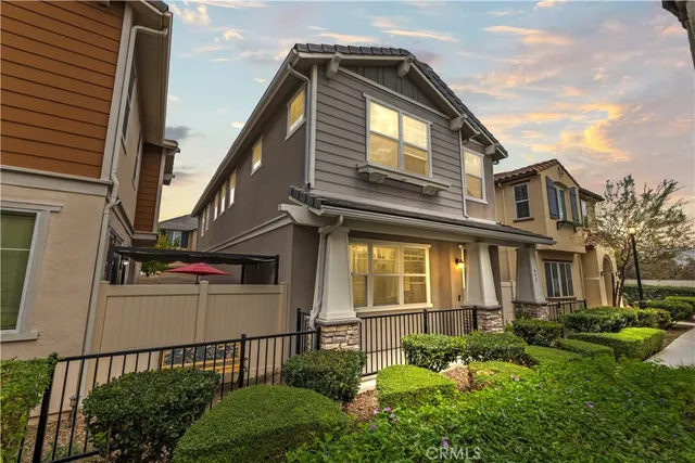 a view of a house with wooden fence