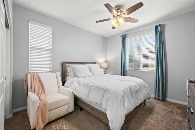 a bedroom with bed and window