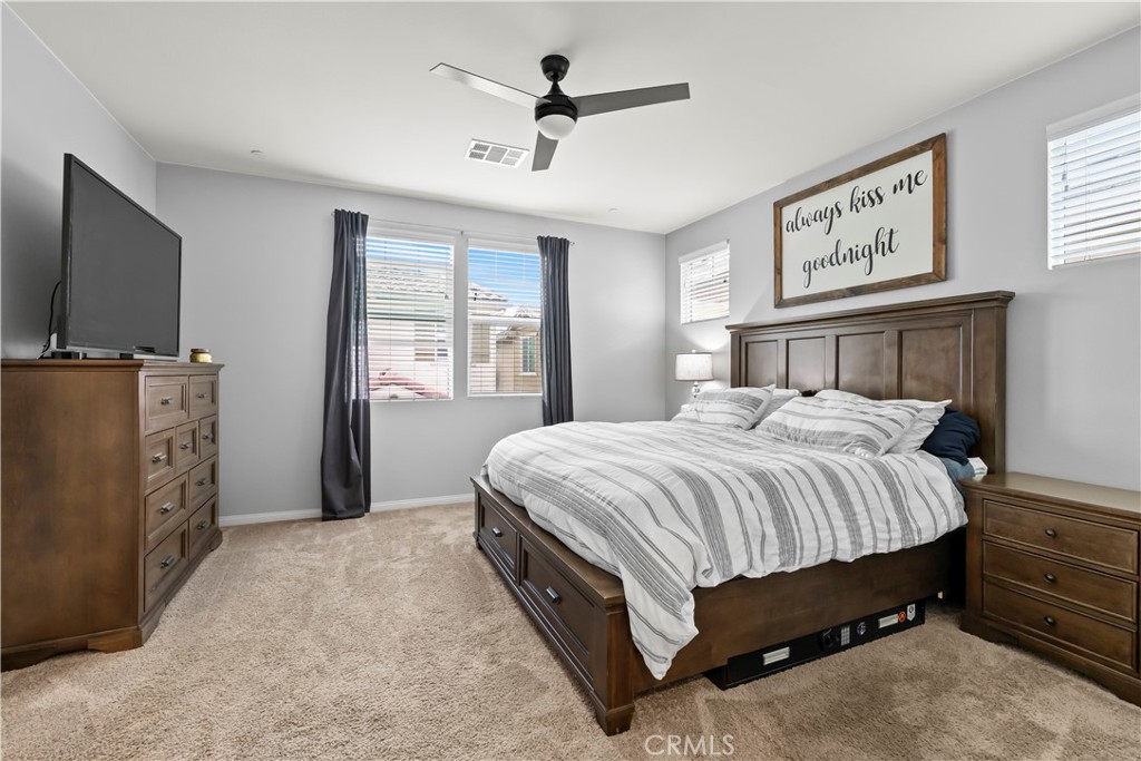 692 South Brampton Avenue Rialto, CA 92376 - Photo 15 of 21 a spacious bedroom with a bed and a flat screen tv