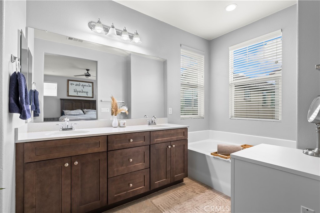 692 South Brampton Avenue Rialto, CA 92376 - Photo 17 of 21 a bathroom with a tub sink and mirror