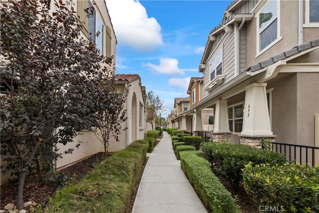 692 South Brampton Avenue Rialto, CA 92376 - Photo 2 of 21 a view of a pathway with house on both side of the road