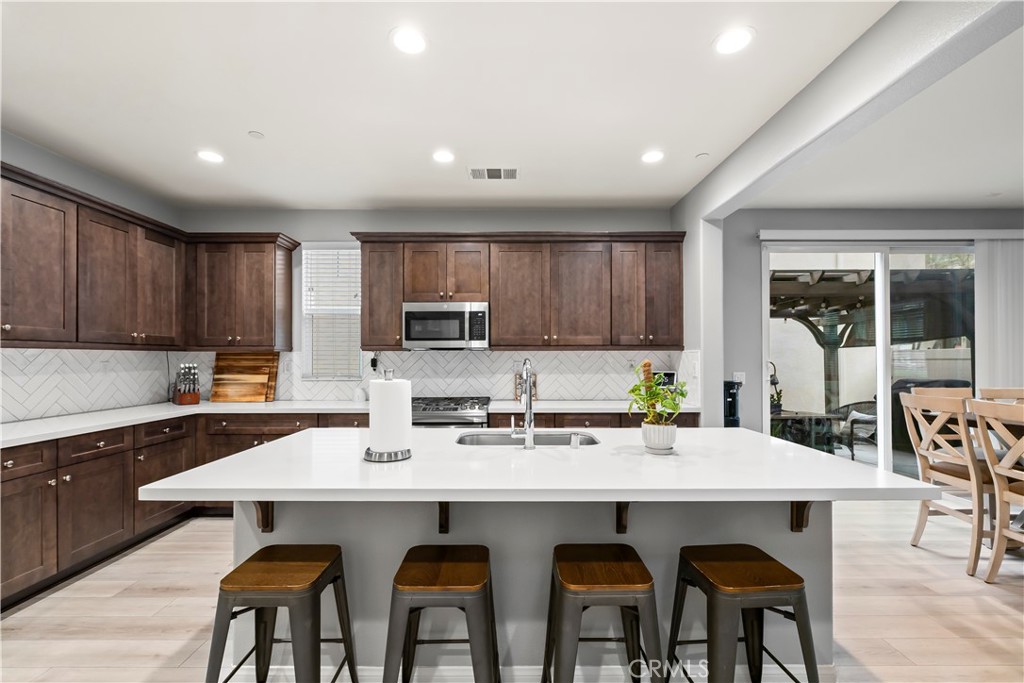 692 South Brampton Avenue Rialto, CA 92376 - Photo 3 of 21 a kitchen with stainless steel appliances stove a sink and microwave