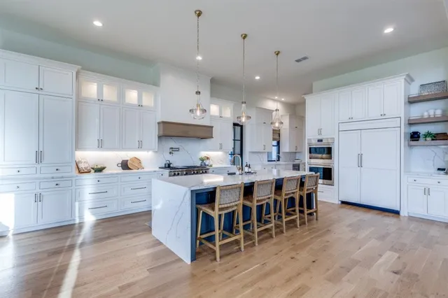 a large kitchen with stainless steel appliances lots of counter space sink and cabinets