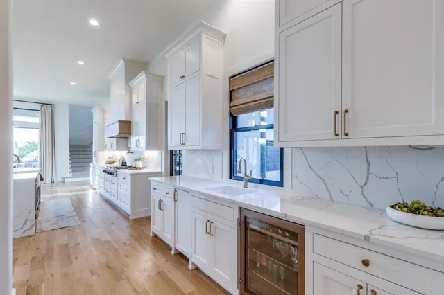a kitchen with a white cabinets and window