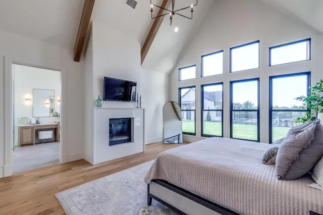 a spacious bathroom with a double vanity sink a large mirror and a bathtub
